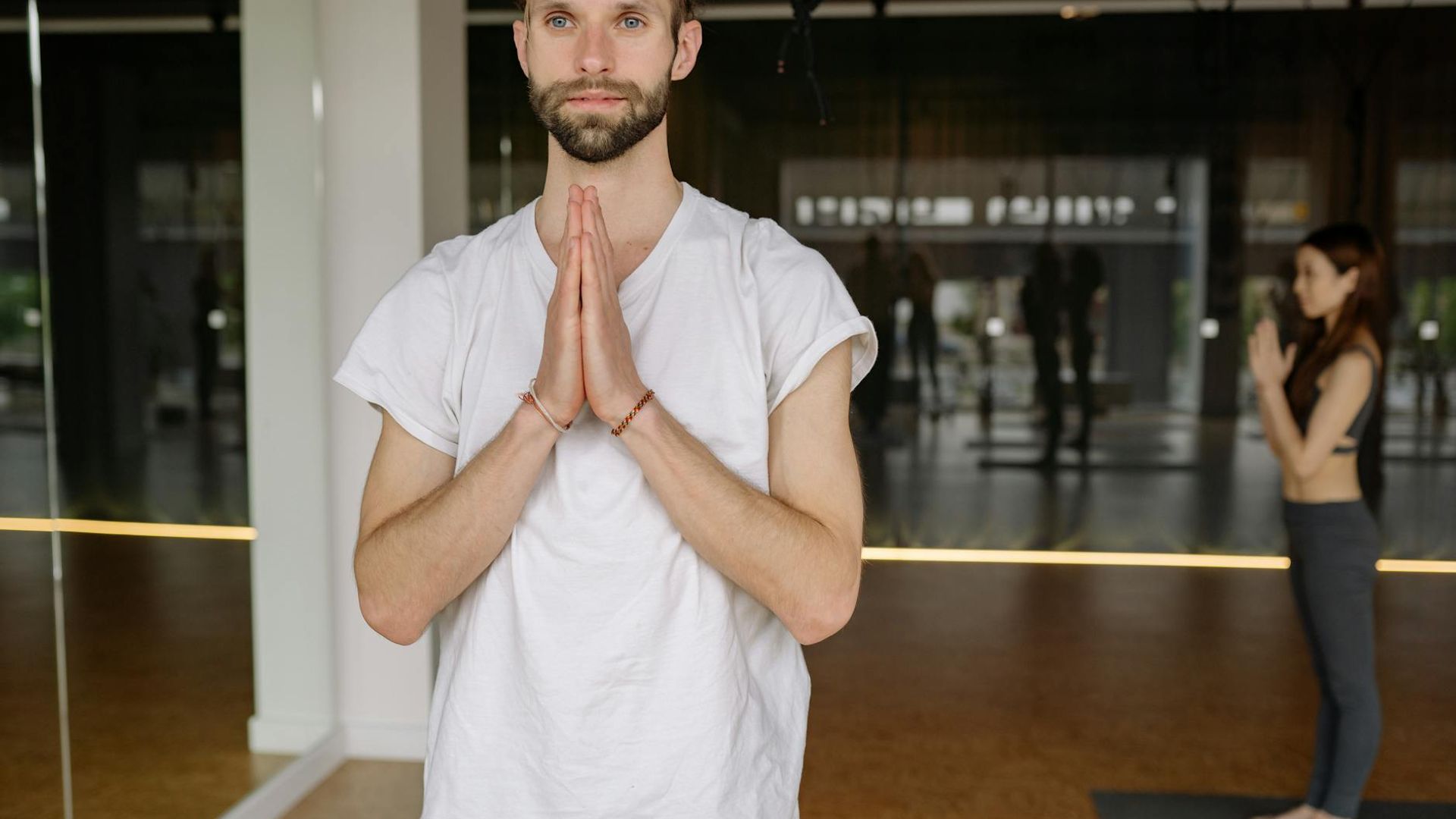 Serene background with a person in a calm, focused yoga posture.
